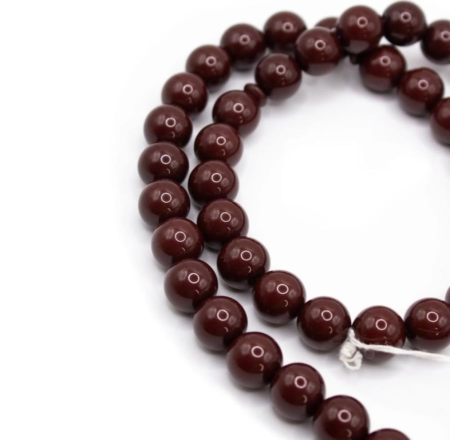 A tasbih with a Bakelite handle, in reddish brown color