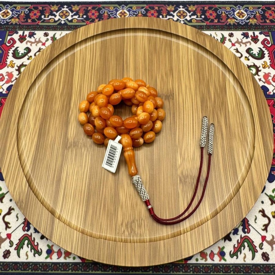 سبحة مسكي عسلي برتقالي – 65 خرزة – قصة بيضاوية – شرابة فضية