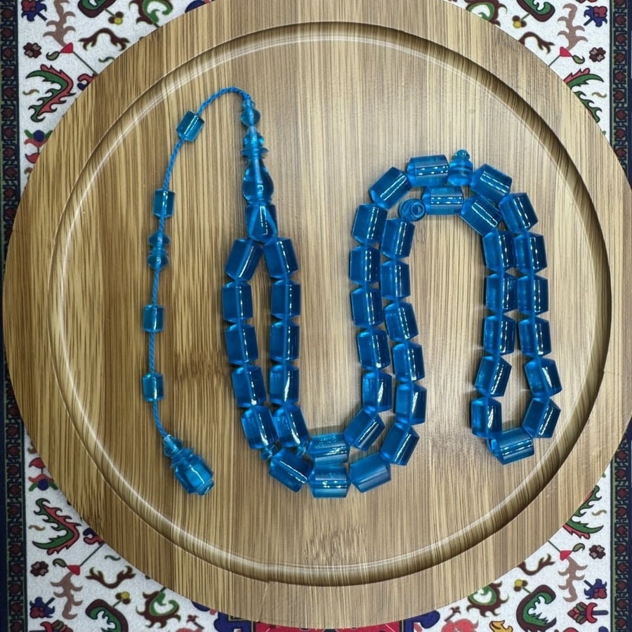Blue transparent plastic prayer beads similar to cast