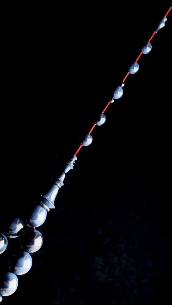 A tasbih with a beaded chain made of old sticks