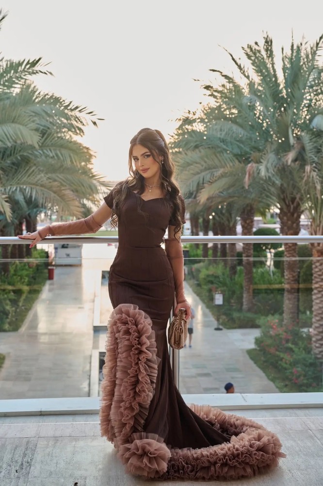 A brown dress with a luxurious crumpled tulle and sleeves