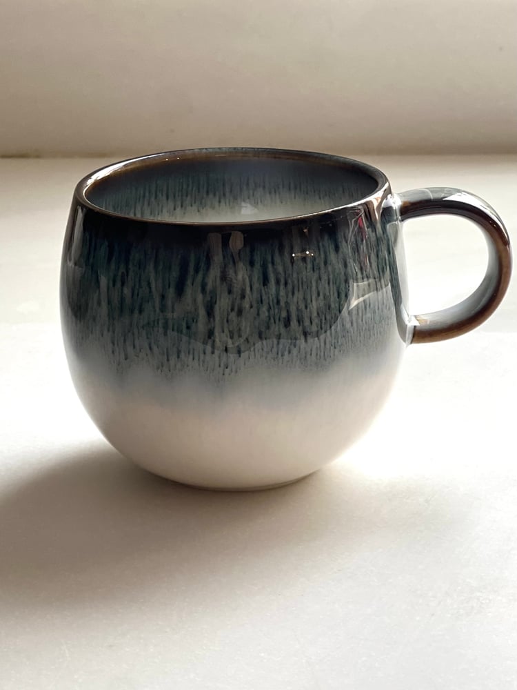 A round porcelain cup in blue and white.