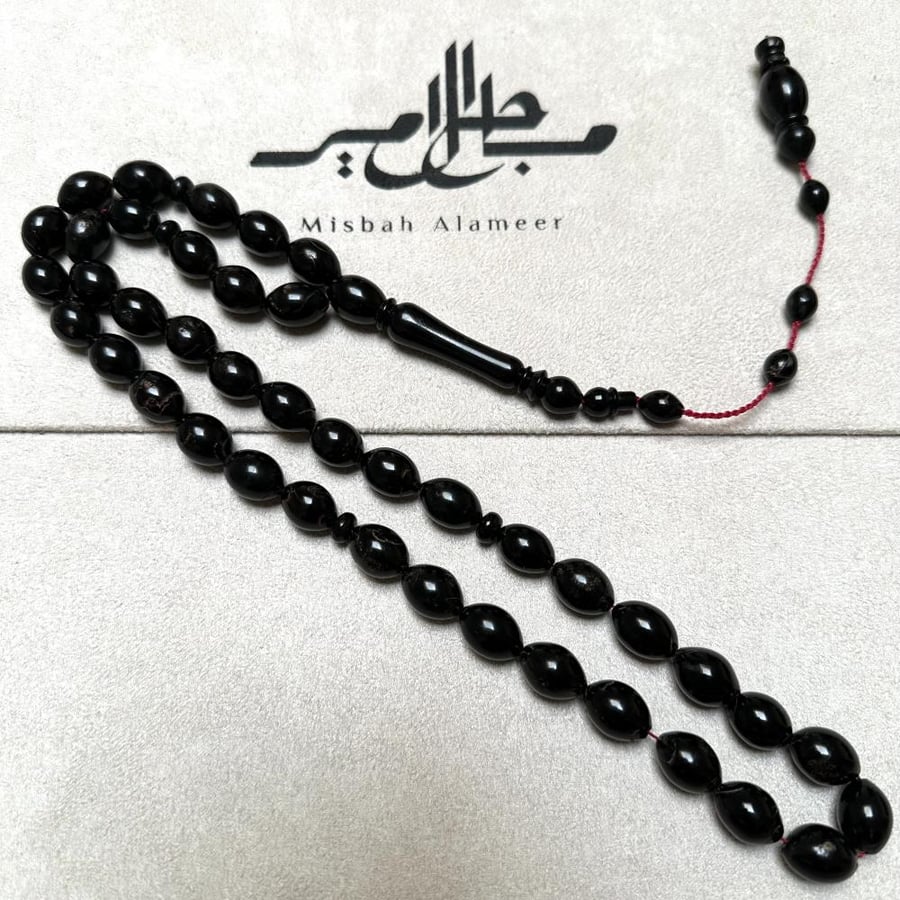 Prayer beads of the Red Sea with a red string