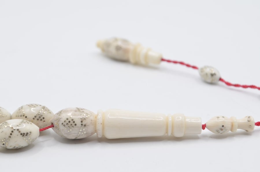 A prayer bead made of bone, plated entirely with silver, Egyptian engraving