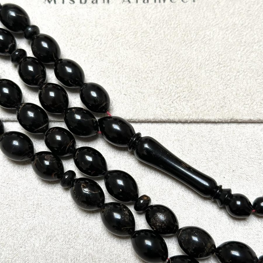 Prayer beads of the Red Sea with a red string