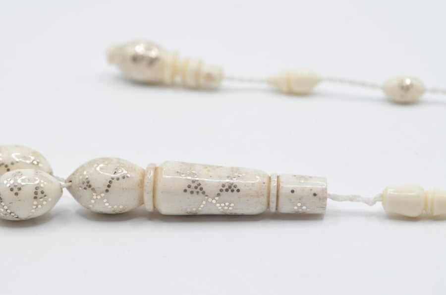 A prayer bead made of bone, plated entirely with silver, Egyptian engraving