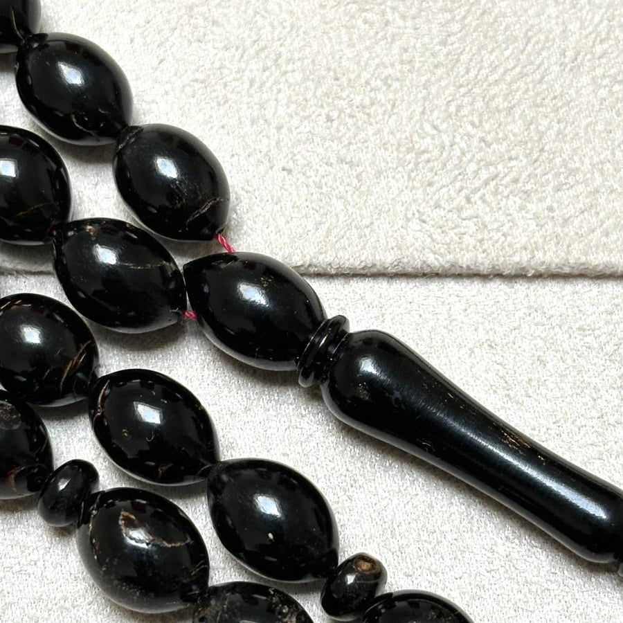 Prayer beads of the Red Sea with a red string
