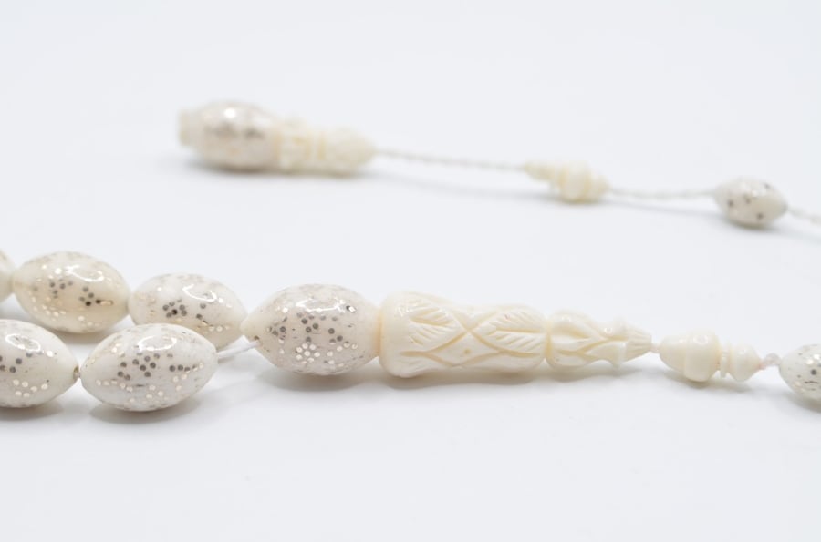 A prayer bead made of bone, plated entirely with silver, Egyptian engraving