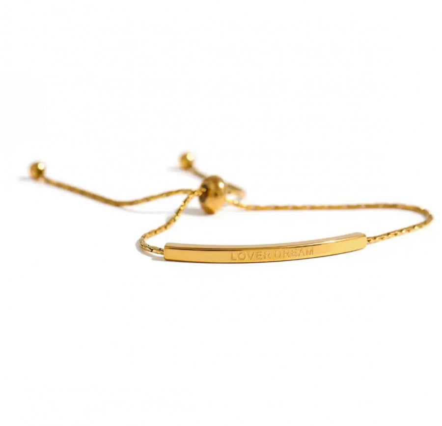 Gold bracelet with the phrase lover dream
