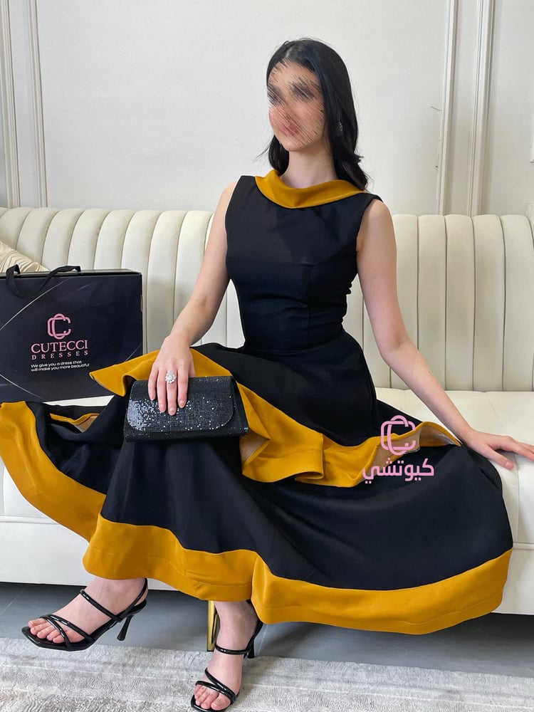 فستان سهرة أسود بلمسة ذهبية بتصميم أنثوي فاخر من كيوتشي