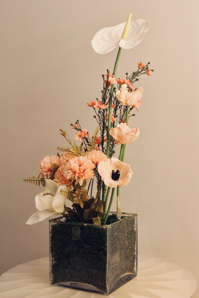 Cube-shaped vase with artificial flowers
