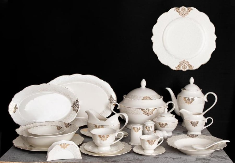 A set of fine porcelain tableware containing plates, bowls, serving dishes, cups, and enough for 6 people, consisting of 71 pieces, in gold color.