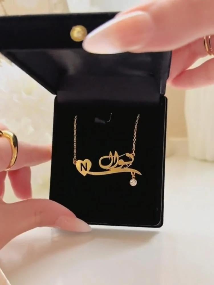 A necklace with the name and letter with a gemstone