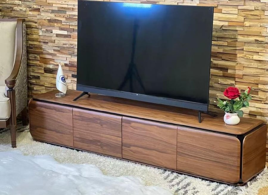 طاولة تلفزيون مودرن فاخرة من الخشب الجوزي بتصميم انسيابي مستدير الحواف