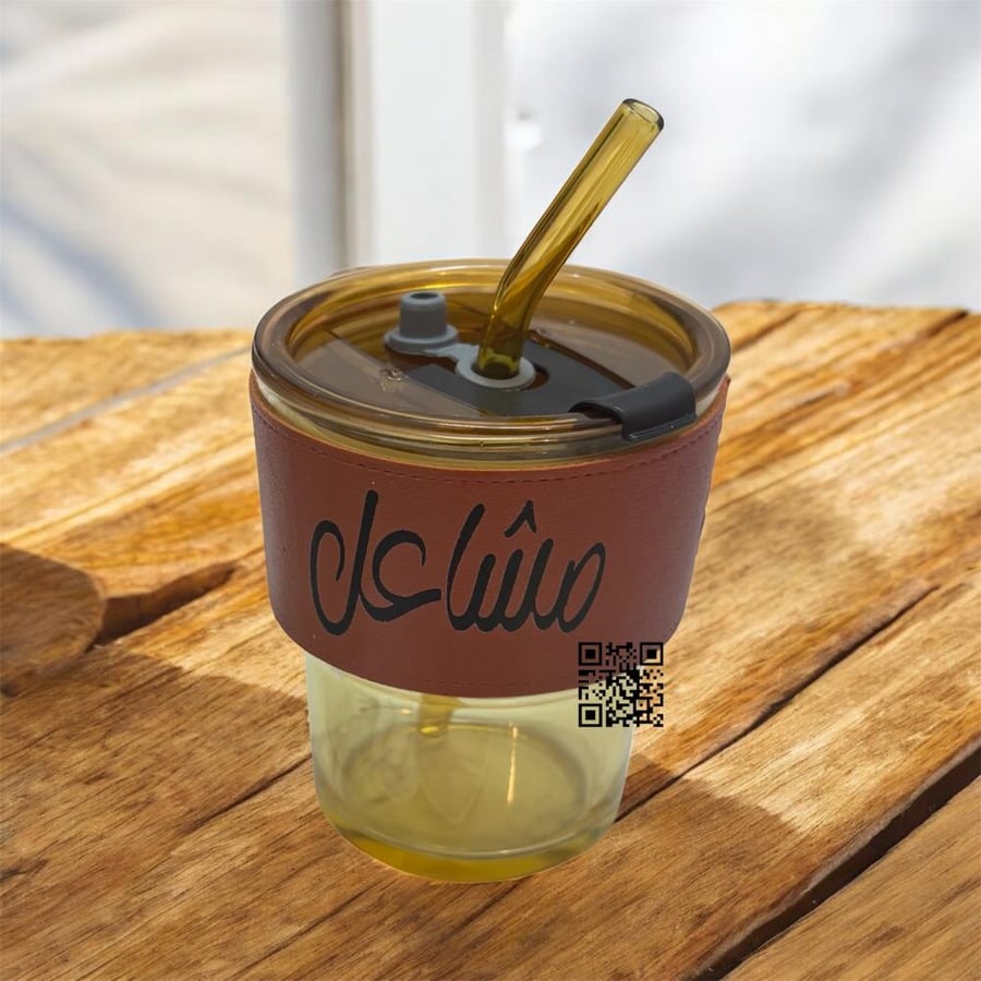 Glass cup with leather handle and writing