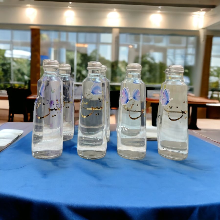 Glass water bottle with writing