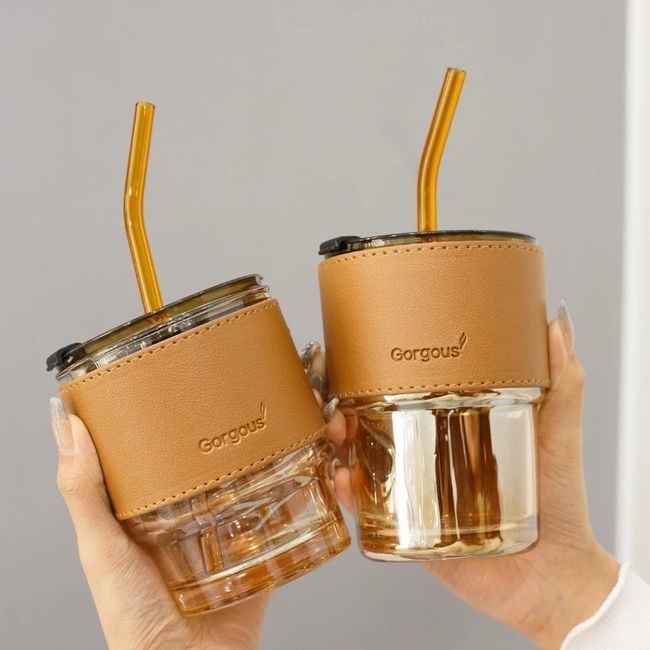 Glass cup with leather handle and writing