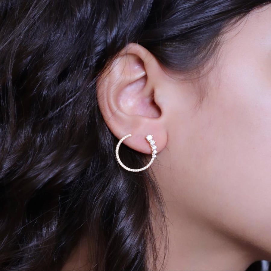 Silver hoop earring with zircon.