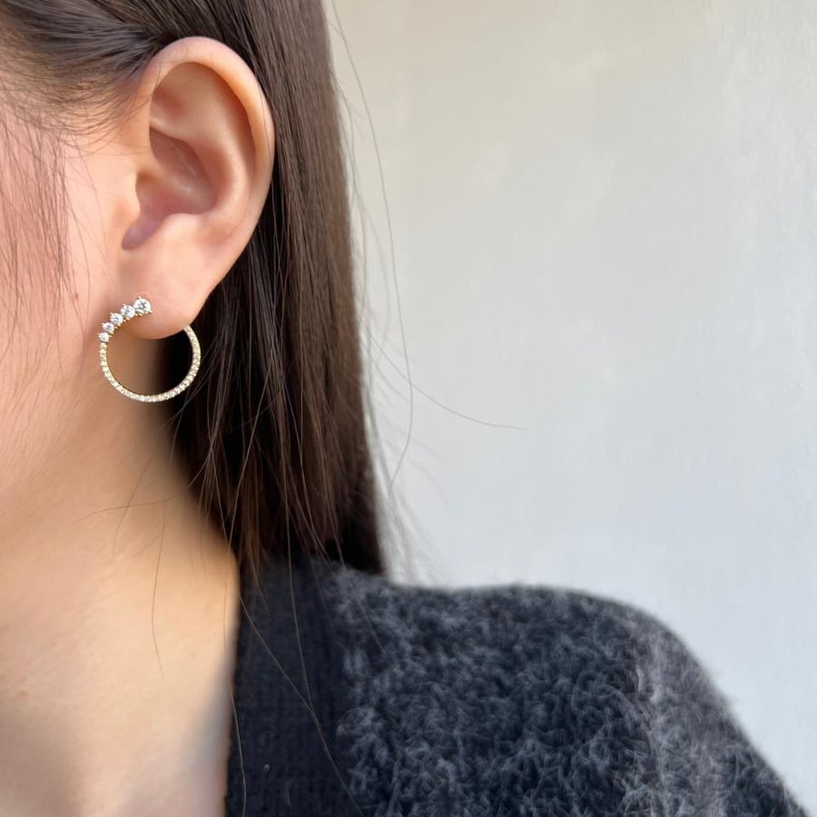 Silver hoop earring with zircon.