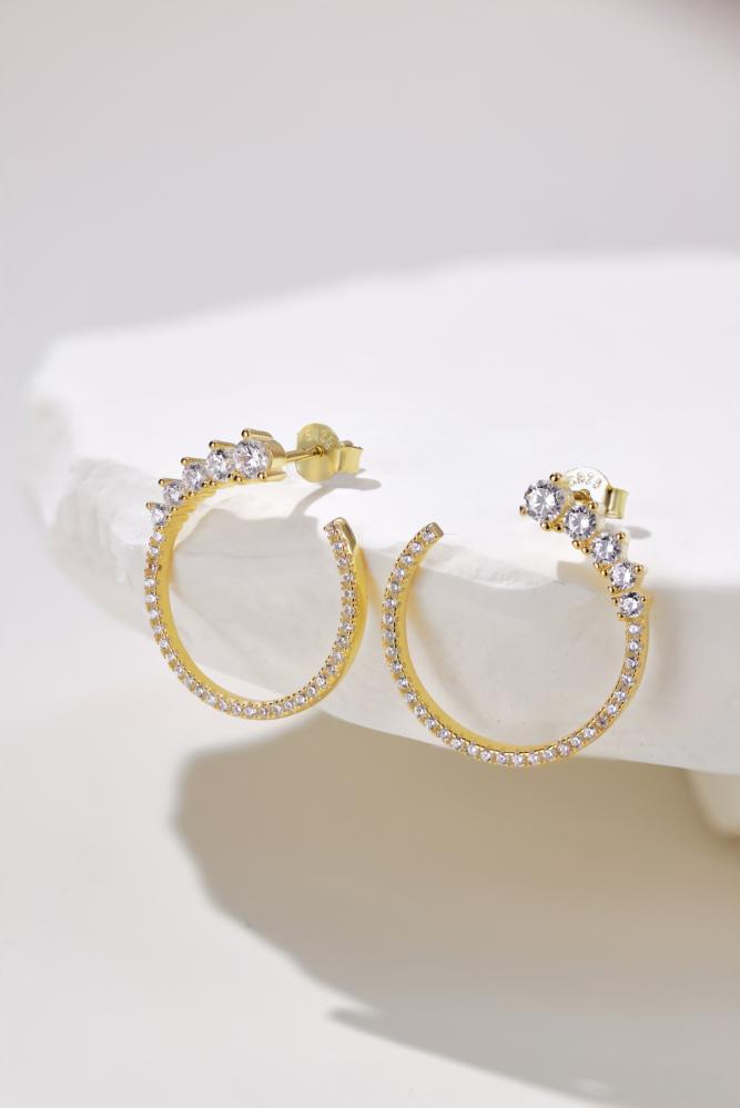 Silver hoop earring with zircon.