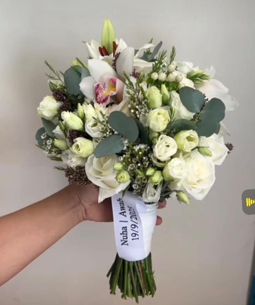 Bride's bouquet of natural Dutch roses with added ribbon of names and date