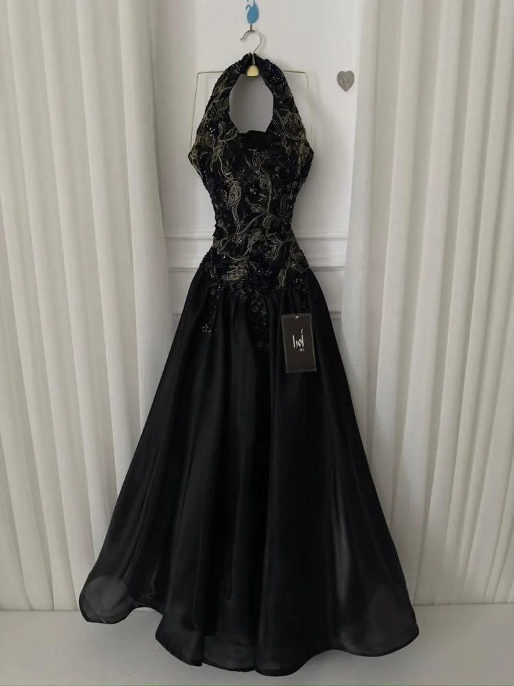 Black dress with a bodice, lace trim, and a shiny finish.