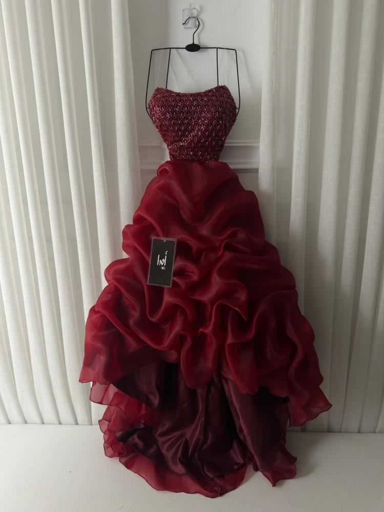 Burgundy dress with a beaded bodice and pleated flared skirt.