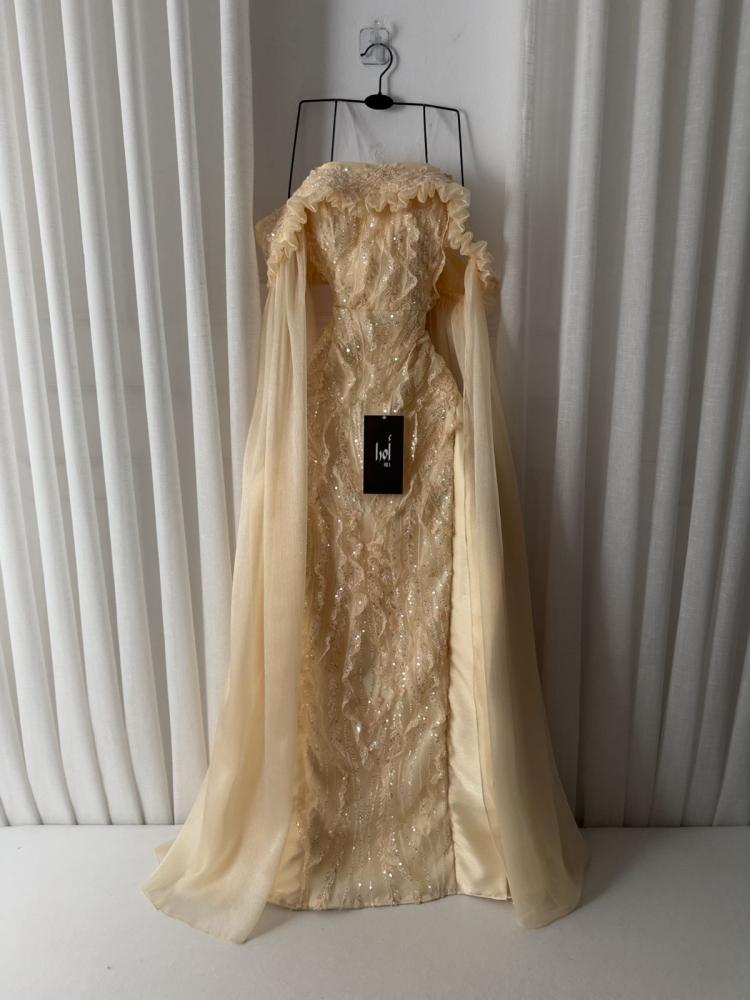 A gold dress with embroidered details, long crinkle sleeves