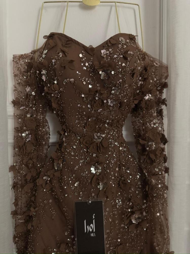A brown dress with a floral print and georgette insert.