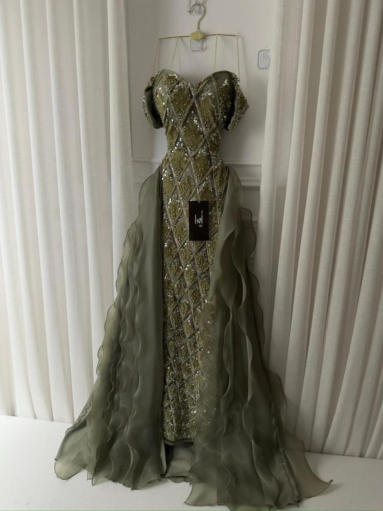 An olive-green dress with a butcher's tail and trim