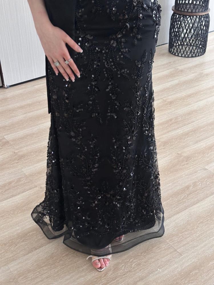 Black sequined evening dress with a butcher's bodice