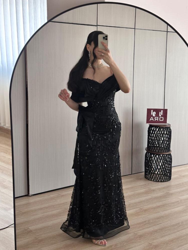 Black sequined evening dress with a butcher's bodice