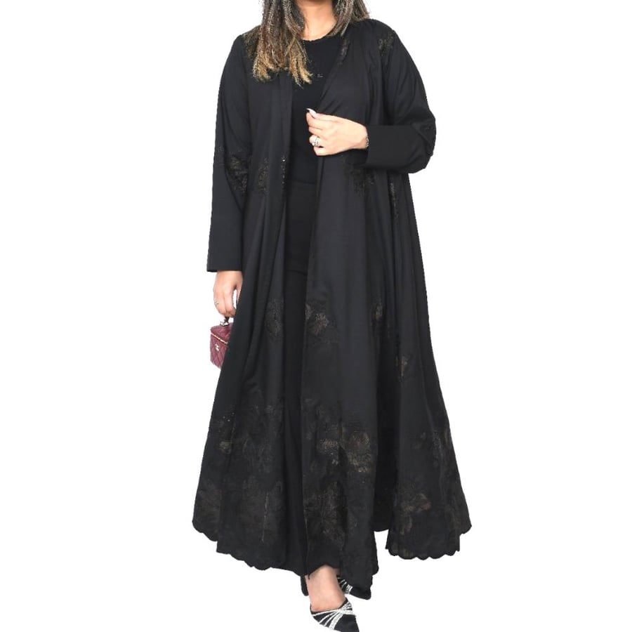 Al Anood abaya, black linen fabric, hand-embroidered, gathered design, with a headscarf.