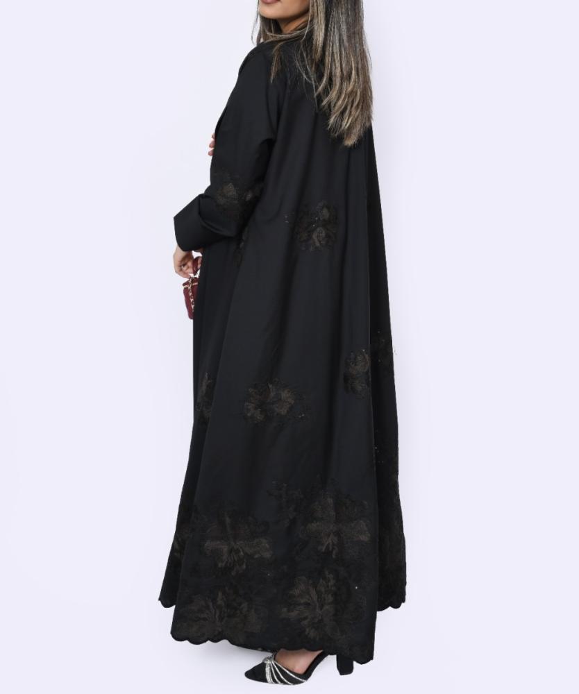 Al Anood abaya, black linen fabric, hand-embroidered, gathered design, with a headscarf.