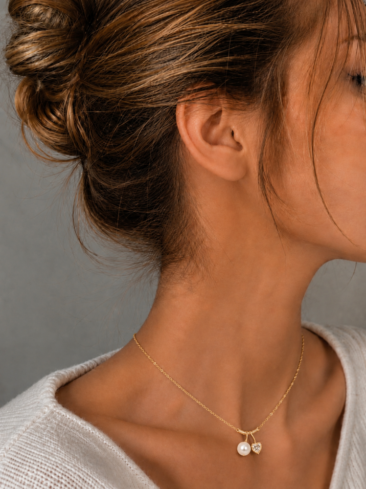 Bow necklace with two crystal hearts - gold