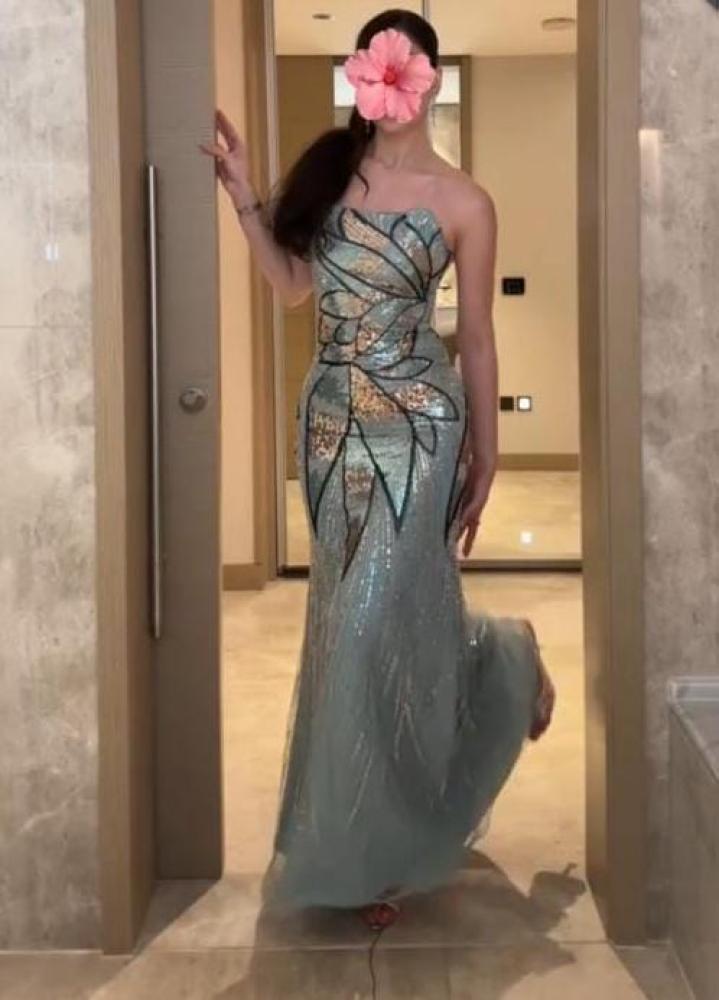 This product is an evening dress sky-colored decorated with embroidery and embellishments.