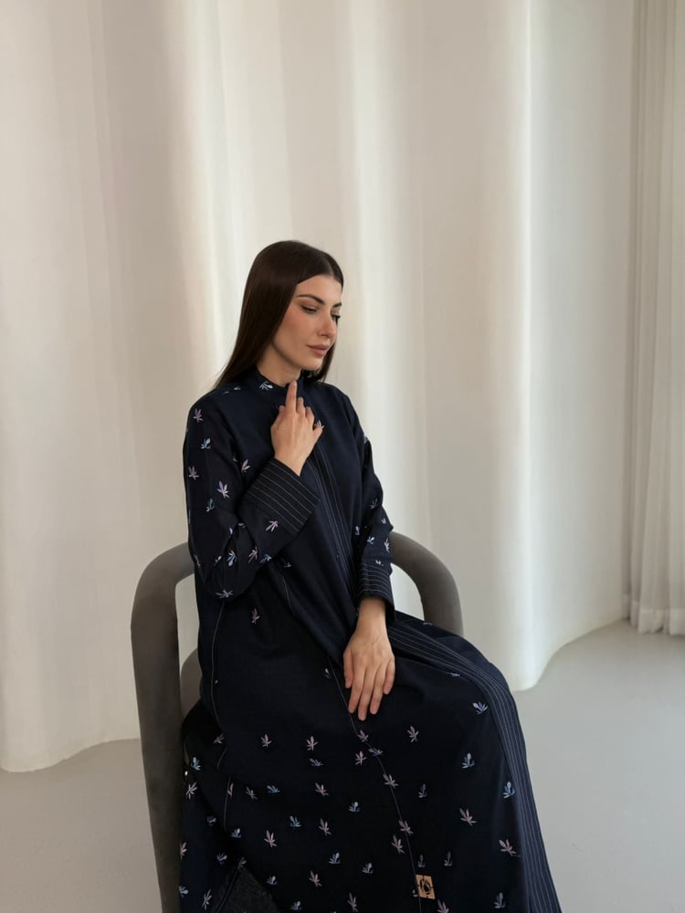 عبايه كحلي من القطن الخفيف المناسب للصيف . العبايه مطرزه بالكامل بألوان زاهيه كالوردي والموڤ الباهت . العبايه تتميز بقصتها الكلوش وقبتها الرسميه
