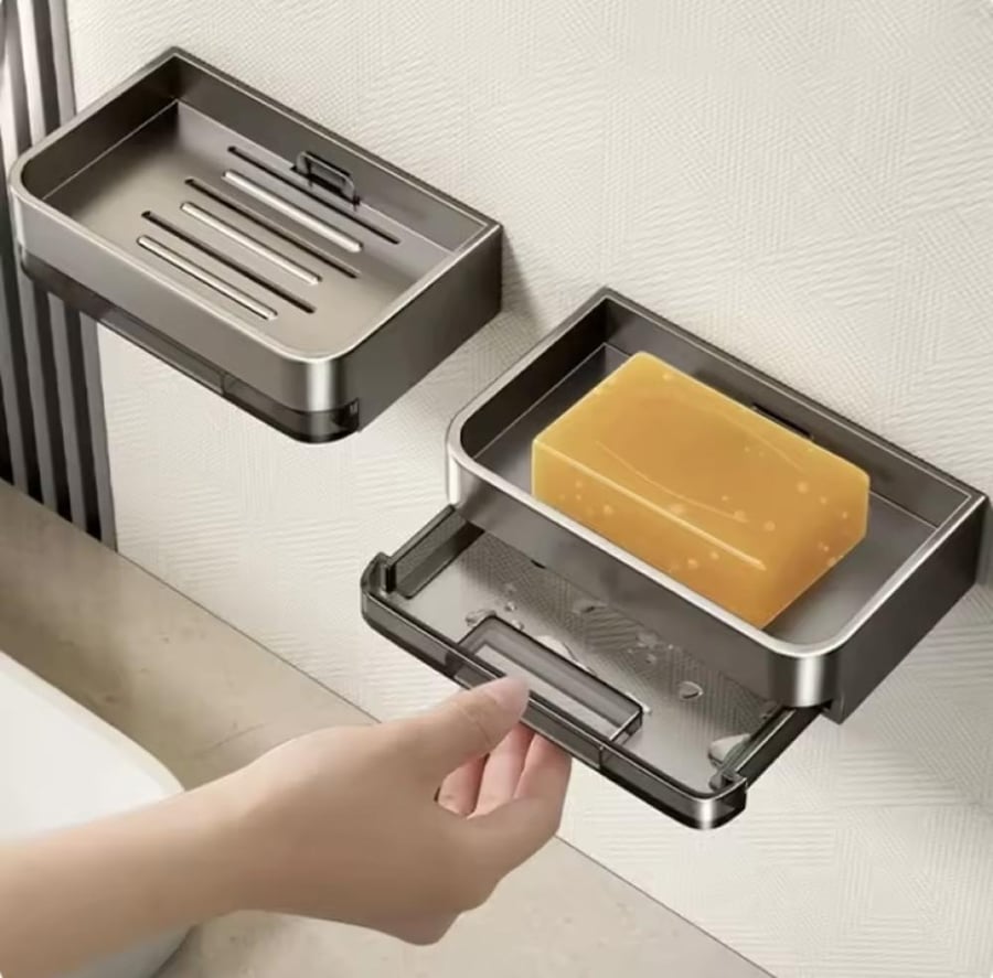 طبق صابون جداري لاصق بتصميم عصري داكن يثبت بدون حفر ويصرف الماء بشكل تلقائي.