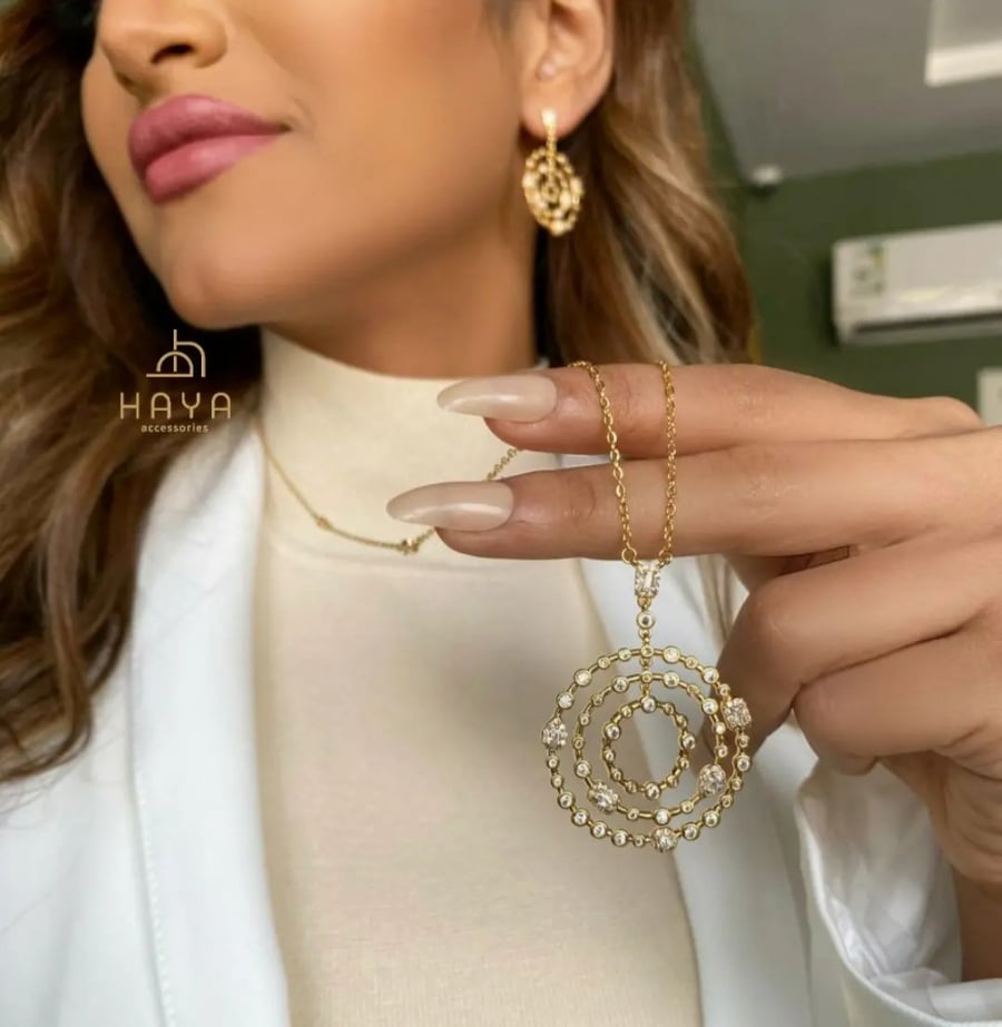 A wonderful set (necklace + earrings) plated and decorated with zircon.