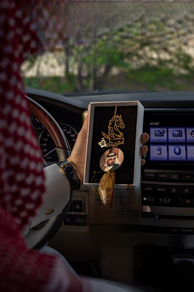 A horse pendant with a piece of oud and a picture of whom you love