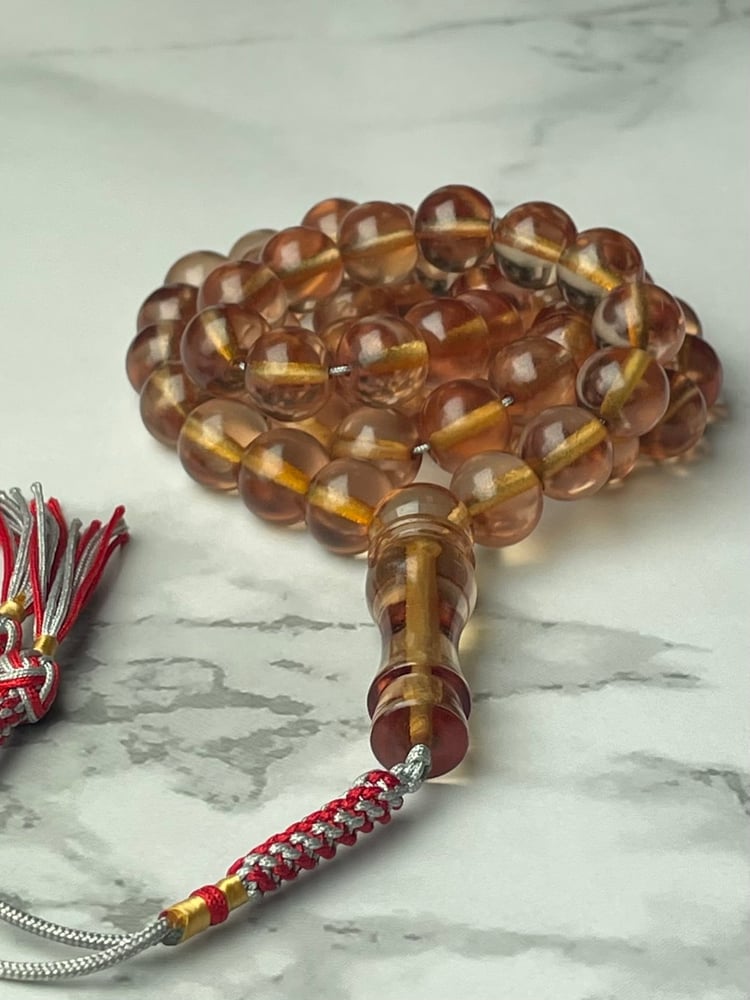 Transparent saffron prayer beads