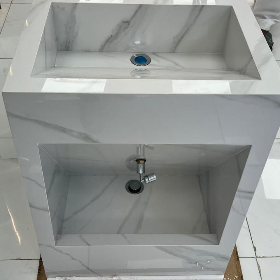 White washbasin with gray mosaic
