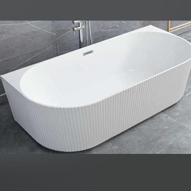 A classic white bathtub above the tiles