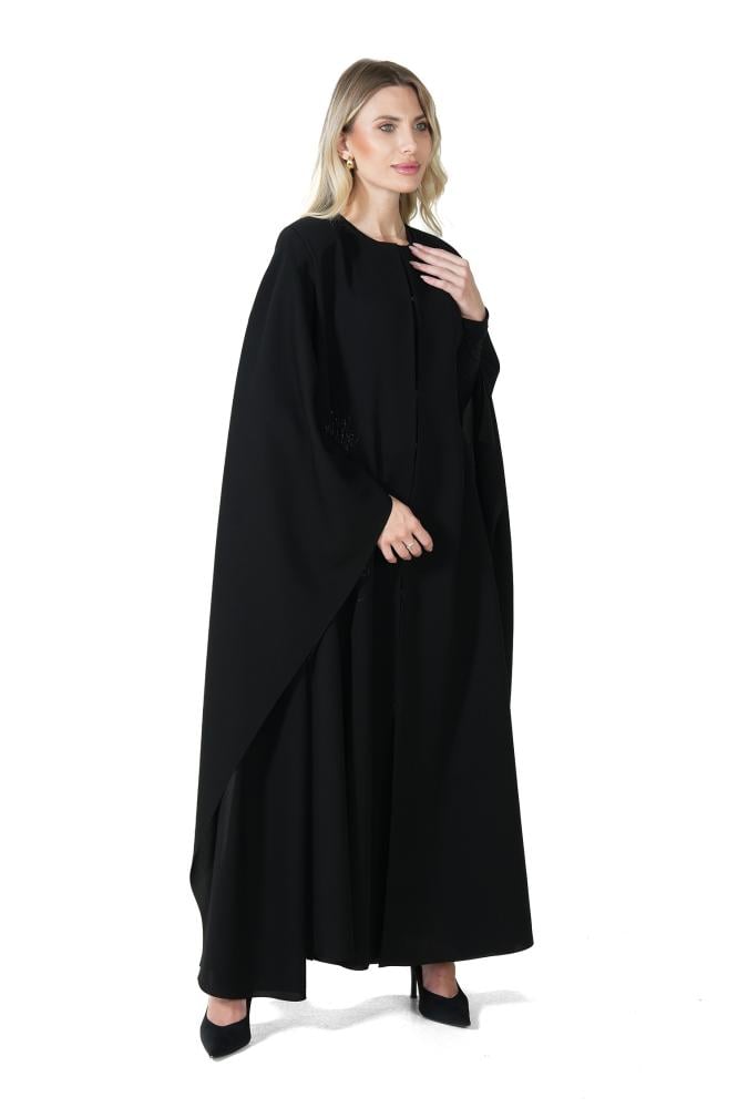A black abaya with a distinctive cut and elegant embroidery.