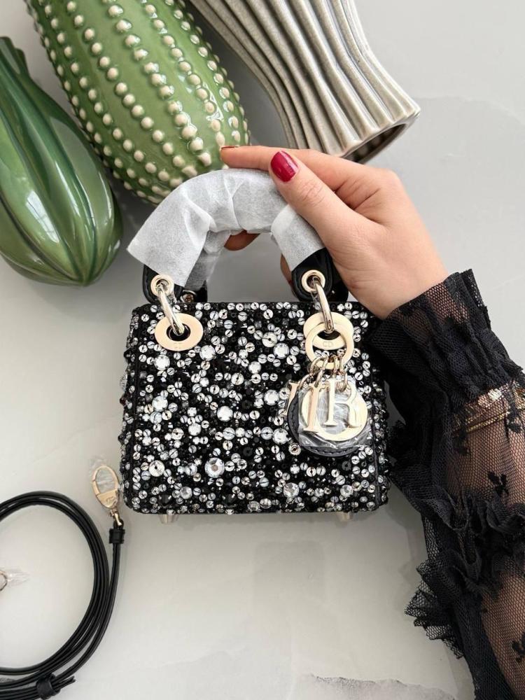 Mini Dior handbag with top handles and shoulder strap in black with white rhinestones