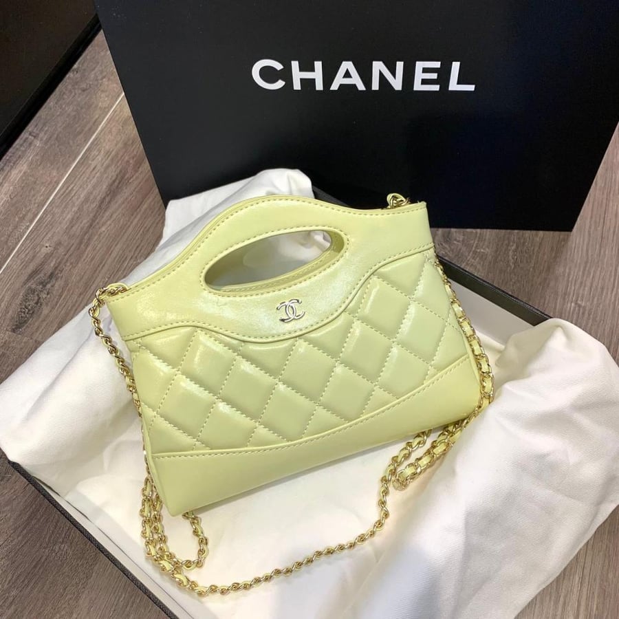 Chanel 31 bag, elegant lemon-colored leather with a gold chain