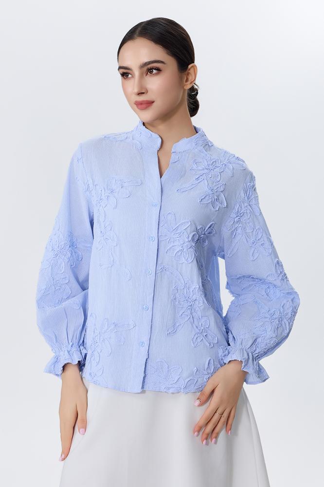 A blouse embroidered with raised flowers in sky blue color