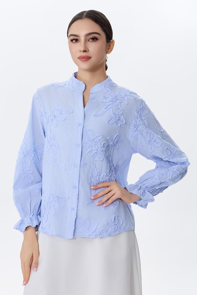 A blouse embroidered with raised flowers in sky blue color