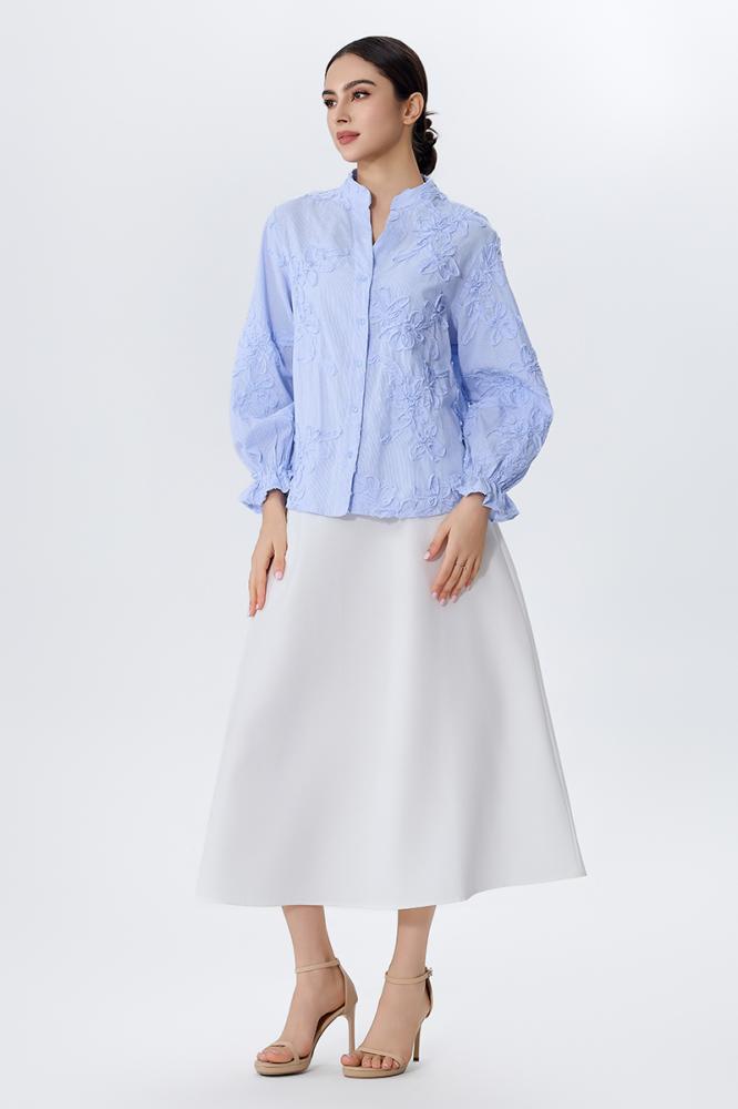 A blouse embroidered with raised flowers in sky blue color