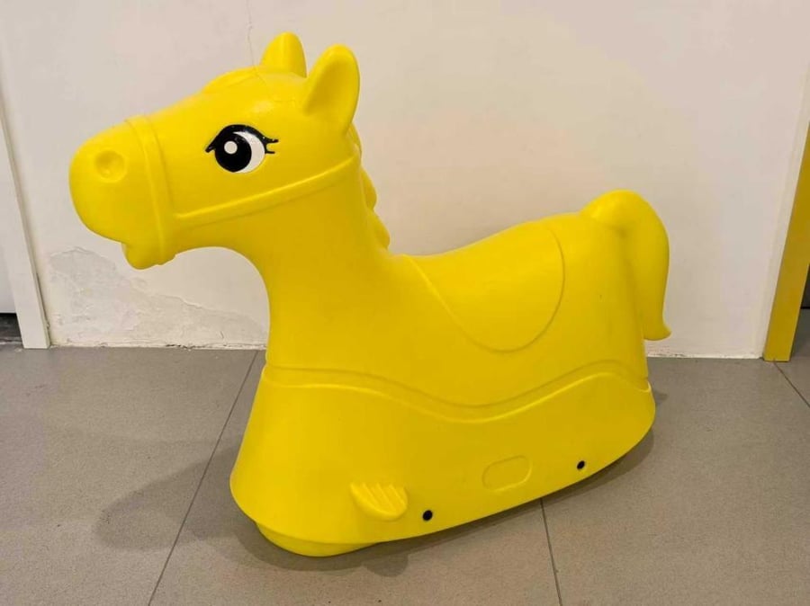 The large rocking horse is yellow.